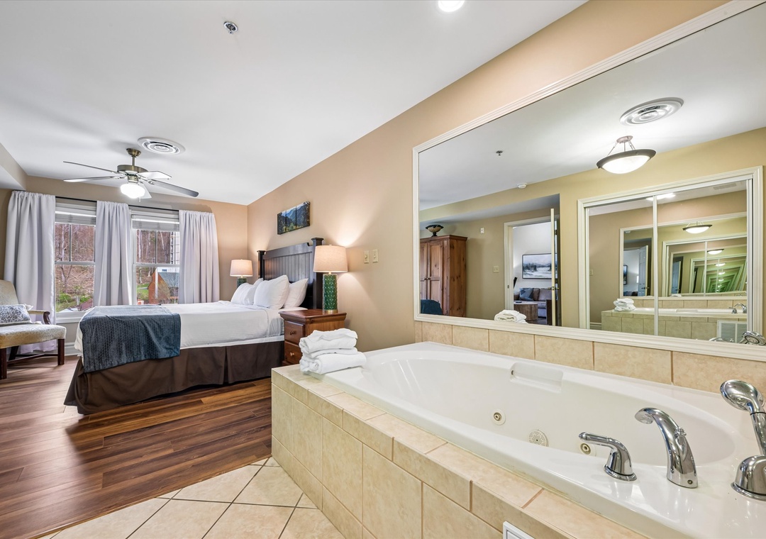 Unwind in your spacious suite featuring a luxurious jetted tub and cozy king bed, perfect for a romantic getaway.