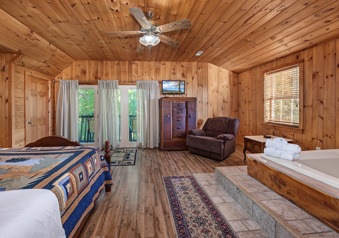 Relax in your spacious cabin suite with rustic wood paneling, a ceiling fan, and cozy furnishings. Unwind with a soak in the jetted tub or enjoy peaceful wooded views from your private balcony.