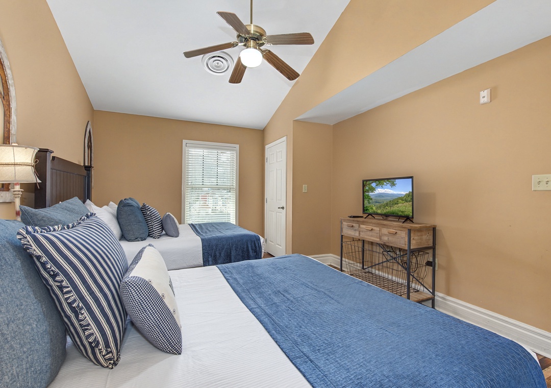 Unwind in your comfortable twin bedroom with soft linens, warm lighting, and entertainment for a restful night.