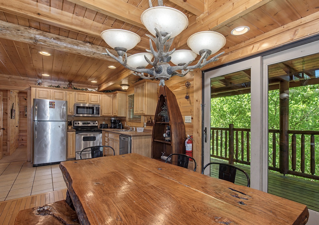 Your rustic kitchen beckons with warm wood throughout, modern appliances, and forest views through sliding doors to your private deck.