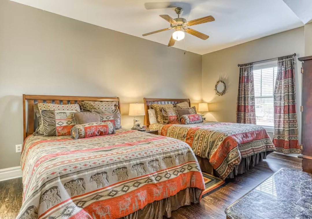 Drift off to sleep in this cozy twin bedroom, where rustic charm meets comfort with warm lighting and Southwestern-inspired decor.