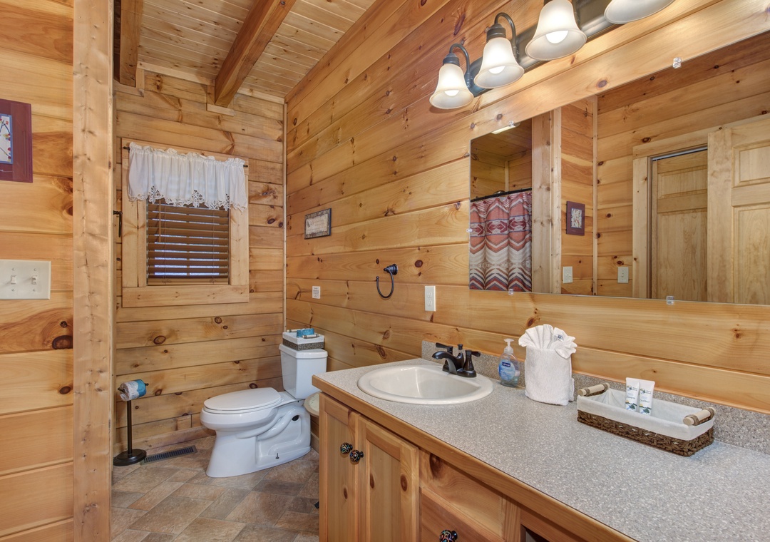 Unwind in your rustic bathroom with warm wood walls and thoughtful cabin touches.
