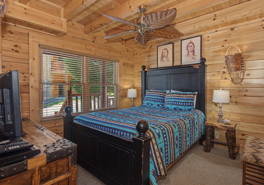 Rest easy in your rustic bedroom featuring warm wood walls, comfortable bedding, and authentic Native American décor creating a peaceful mountain retreat atmosphere.