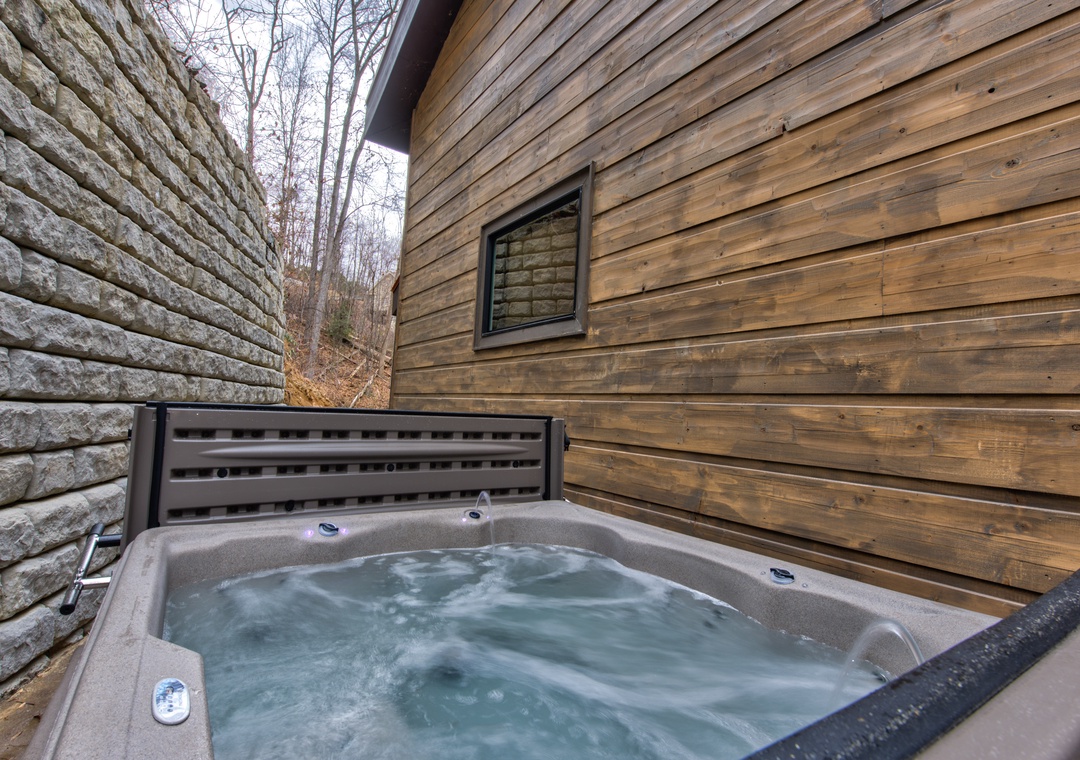 Soak your worries away in your private hot tub, surrounded by natural wood and peaceful forest views.
