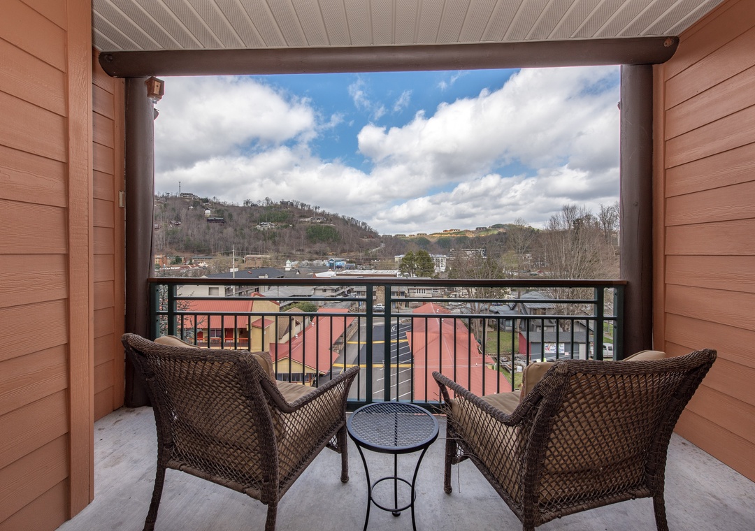 Unwind on your private balcony with wicker seating while taking in sweeping mountain views and charming town scenery below.
