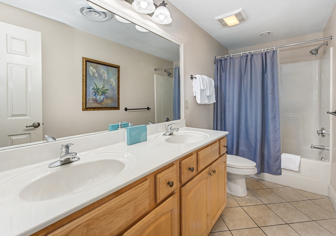 Your spacious bathroom features dual sinks, ample counter space, and a relaxing tub-shower combo for your comfort.