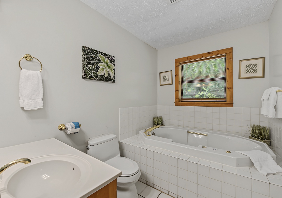 Unwind in your private bathroom with a jetted soaking tub, perfect for melting away stress. Fresh towels and natural light create a peaceful retreat just for you.