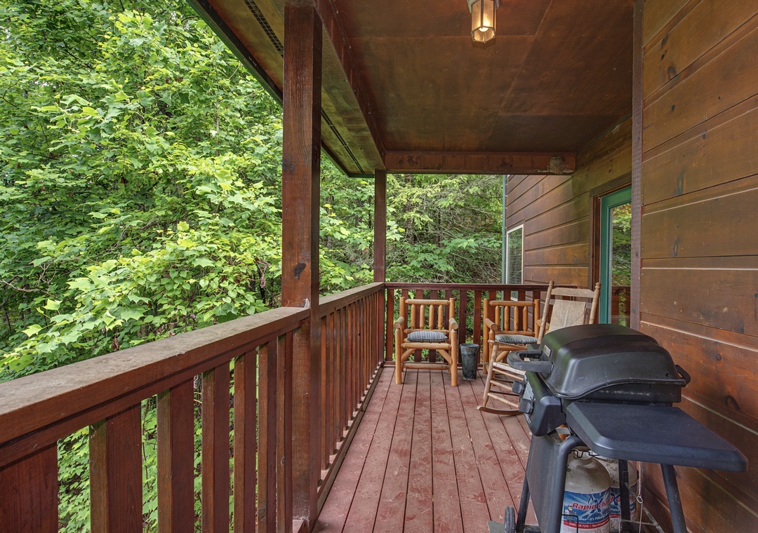 Your private covered deck overlooks lush green woods, perfect for morning coffee in your rocking chairs or evening cookouts on the grill.