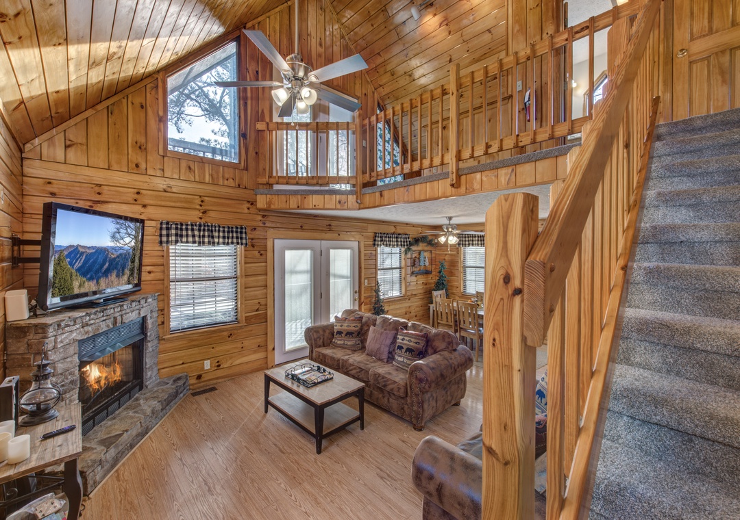 Cozy up in this rustic living room where crackling flames and mountain views create your perfect retreat atmosphere.