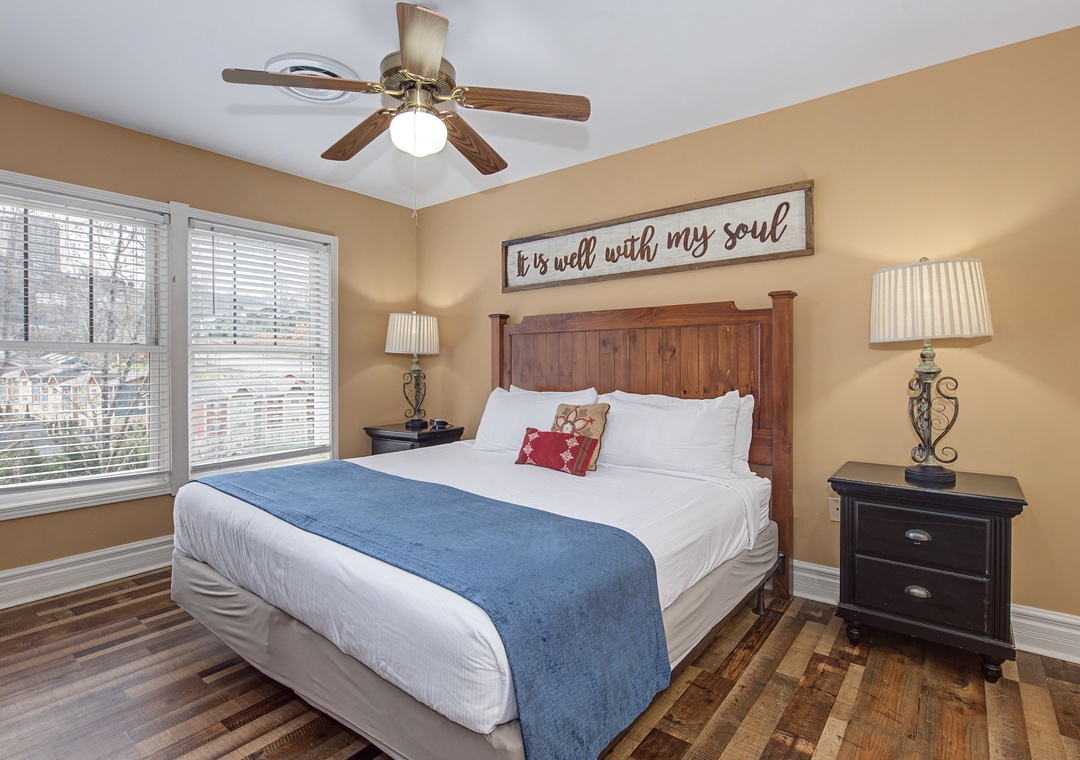 Sink into crisp white linens and enjoy warm wood tones in this serene bedroom retreat.