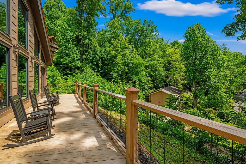Settle into a rocking chair on your private deck and drink in the stunning forest views. Surrounded by towering trees and natural beauty, this peaceful spot invites you to unwind and reconnect with nature.