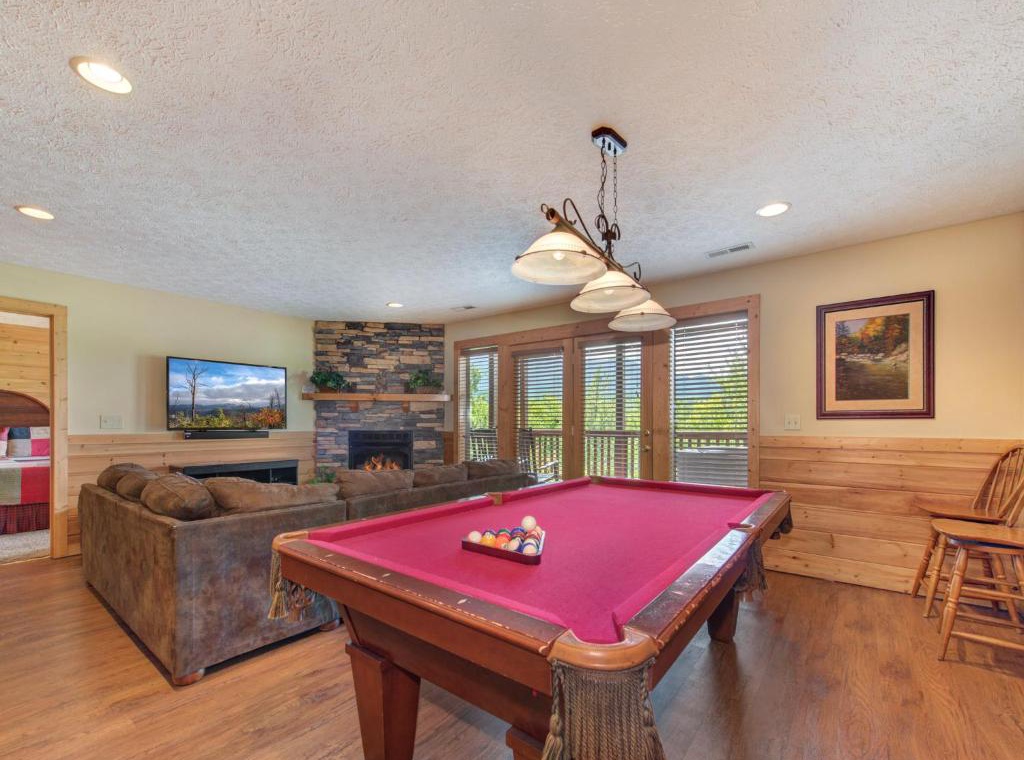 Challenge friends to pool while enjoying your cozy fireplace lounge with mountain views through sliding glass doors.
