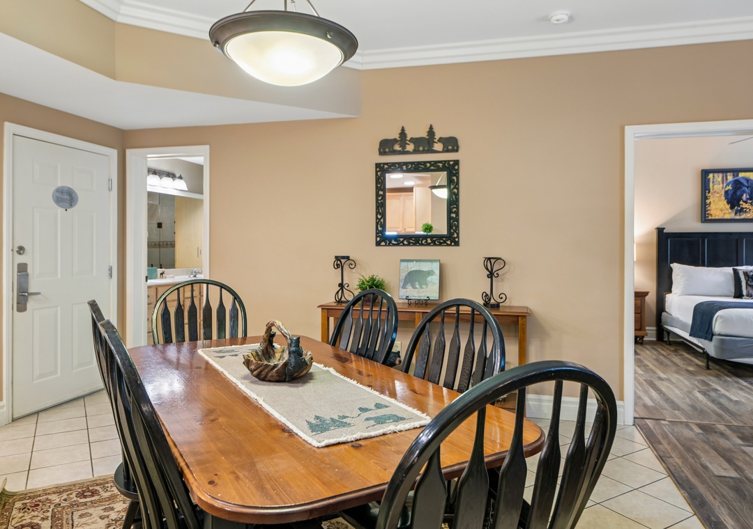 Gather around your elegant dining table for memorable meals with loved ones in this warm, inviting space.