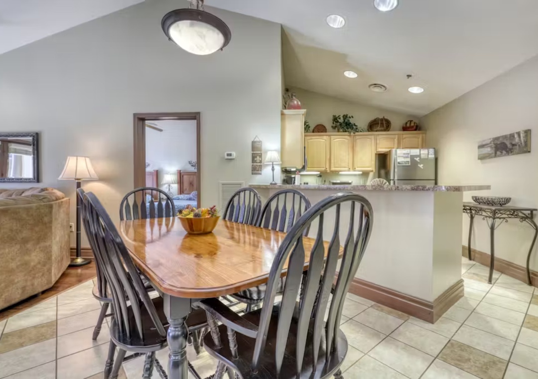 Gather your family around this spacious dining table, perfectly positioned between the cozy living area and modern kitchen for memorable meals.