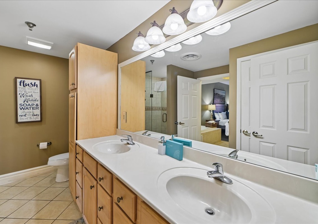 Freshen up in your spacious bathroom with dual sinks, perfect for couples getting ready together for your beach adventures.
