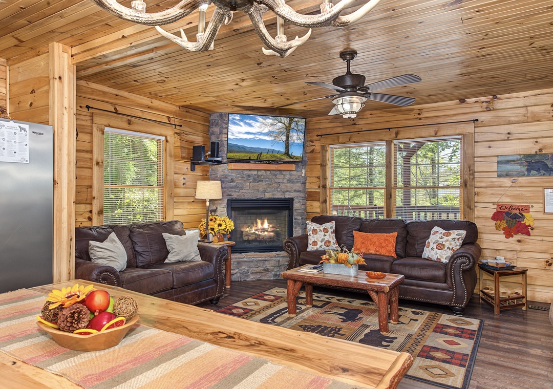 Relax in your cozy cabin retreat, where rustic wood walls and a warm stone fireplace create the perfect mountain escape after a day of adventure.