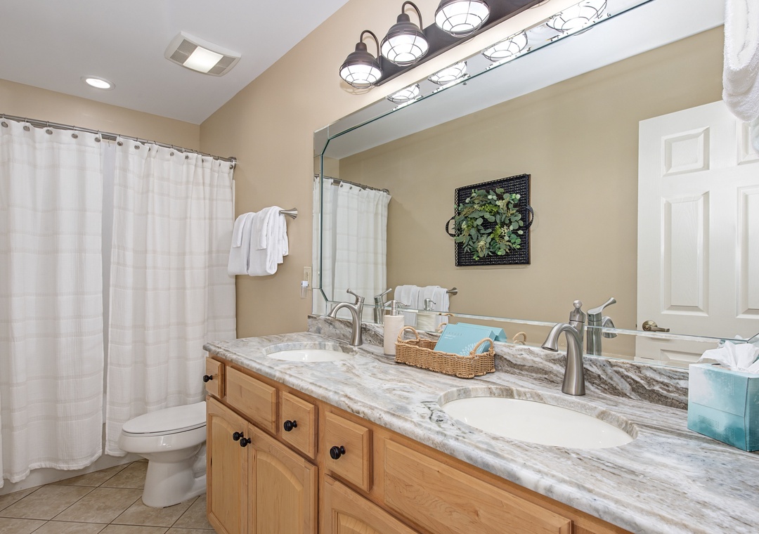 Refresh in your spacious bathroom with dual sinks, marble countertops, and a relaxing tub-shower combo.