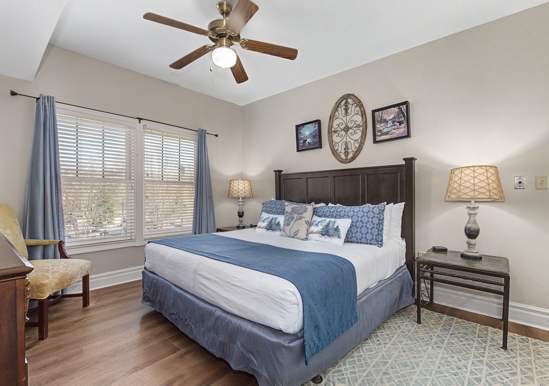 Drift off to sleep in your peaceful retreat, where soft blue linens and gentle ceiling fan breezes create the perfect sanctuary for rest.
