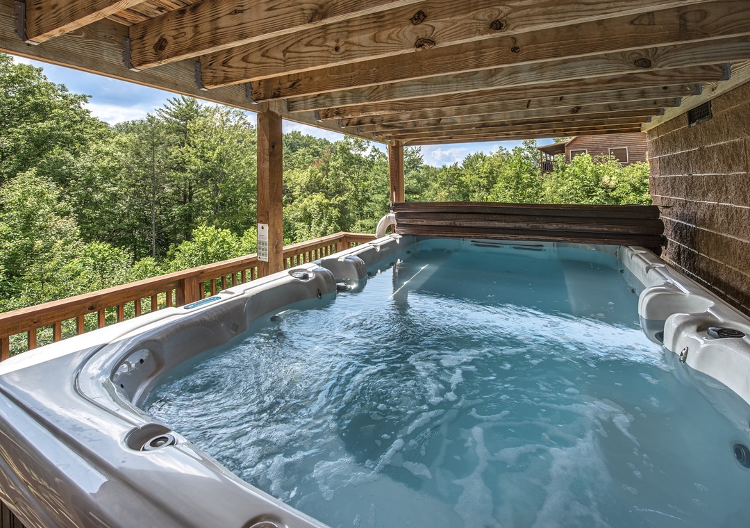 Soak in your private hot tub on the covered deck while lush forest surrounds you. Feel the warm bubbles melt away stress as you breathe in fresh mountain air and soak in the peaceful treetop views.