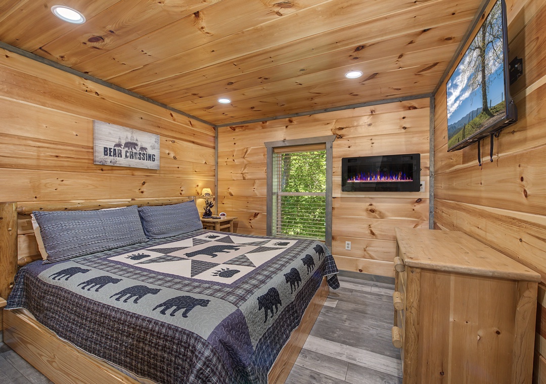 Sink into your cozy cabin retreat with rustic wood walls, a plush king bed, and a warm electric fireplace to unwind after exploring the mountains.