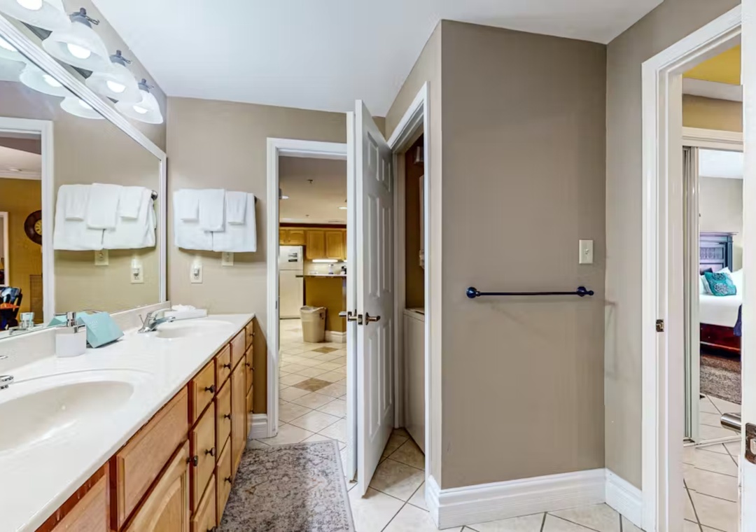 Your spacious bathroom features dual vanities and crisp white countertops, perfect for getting ready together in comfort.