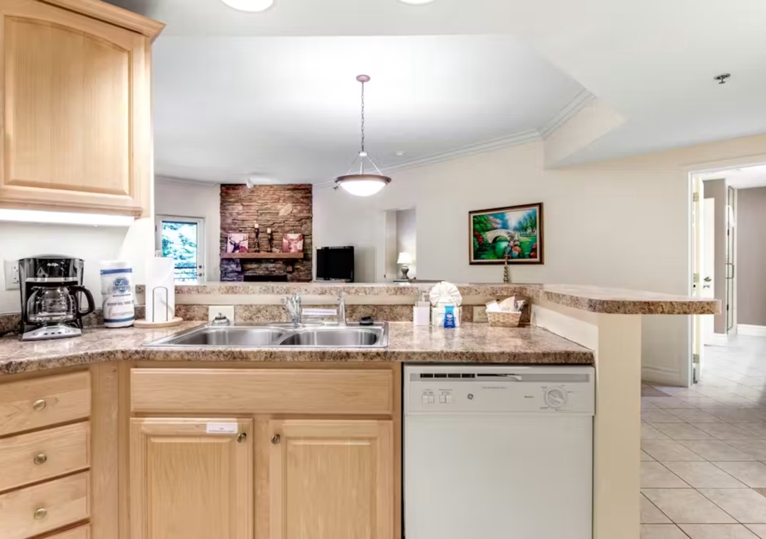 Your spacious kitchen features granite counters, wood cabinets, and modern appliances for comfortable meal prep during your stay.