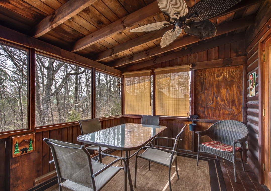 Your private screened porch offers rustic charm with panoramic forest views, perfect for morning coffee or evening relaxation.