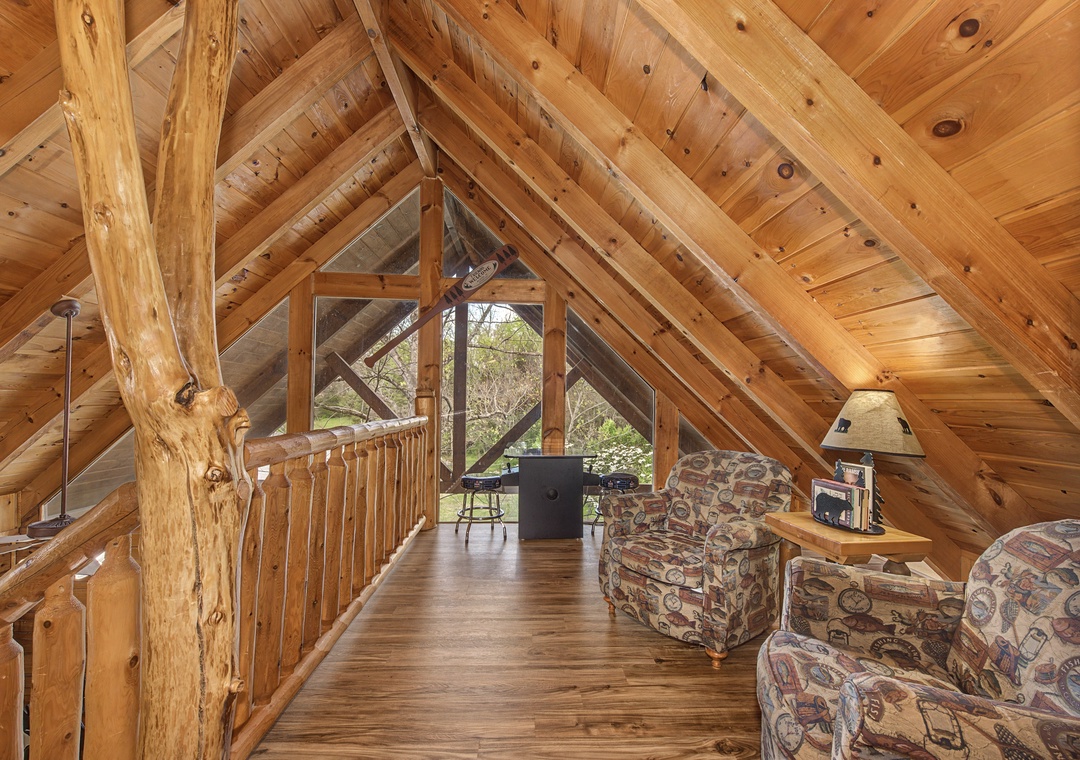 Your cozy loft retreat features soaring wood beam ceilings and comfortable seating where you can unwind after exploring nature.