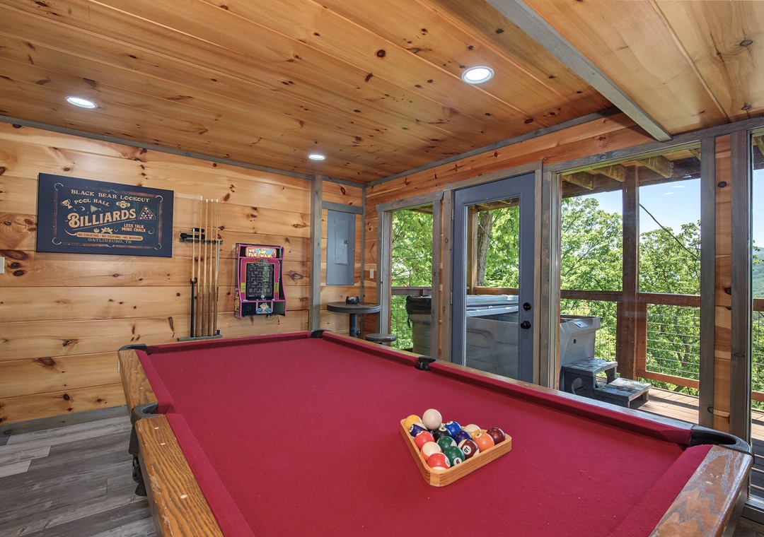 Challenge friends to a game while soaking in stunning mountain views through floor-to-ceiling windows. This entertainment space blends rustic charm with fun, letting you unwind in style.