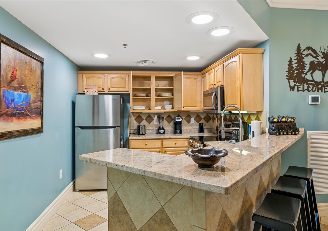 Your fully equipped kitchen features granite countertops, stainless steel appliances, and a breakfast bar where you can sip morning coffee.