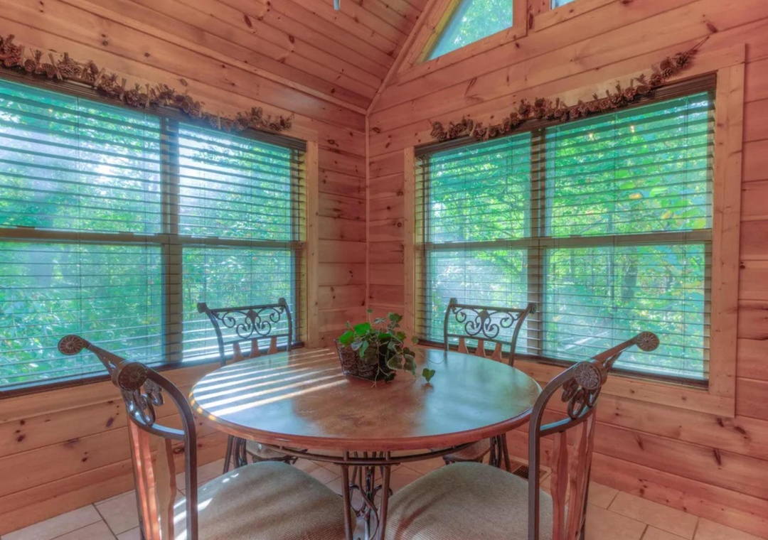 Enjoy your morning coffee at this charming dining nook, where natural light and lush forest views create the perfect start to your day.