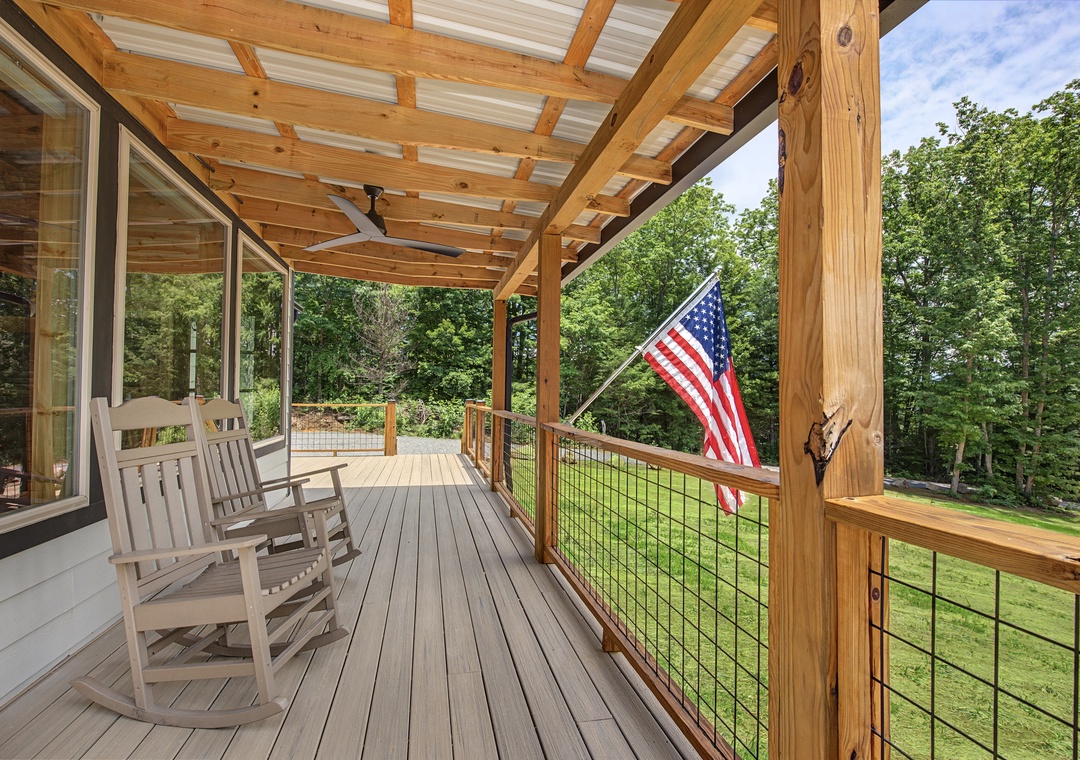 Relax in your rocking chair under the covered deck, gazing at peaceful wooded views and lush greenery stretching before you.