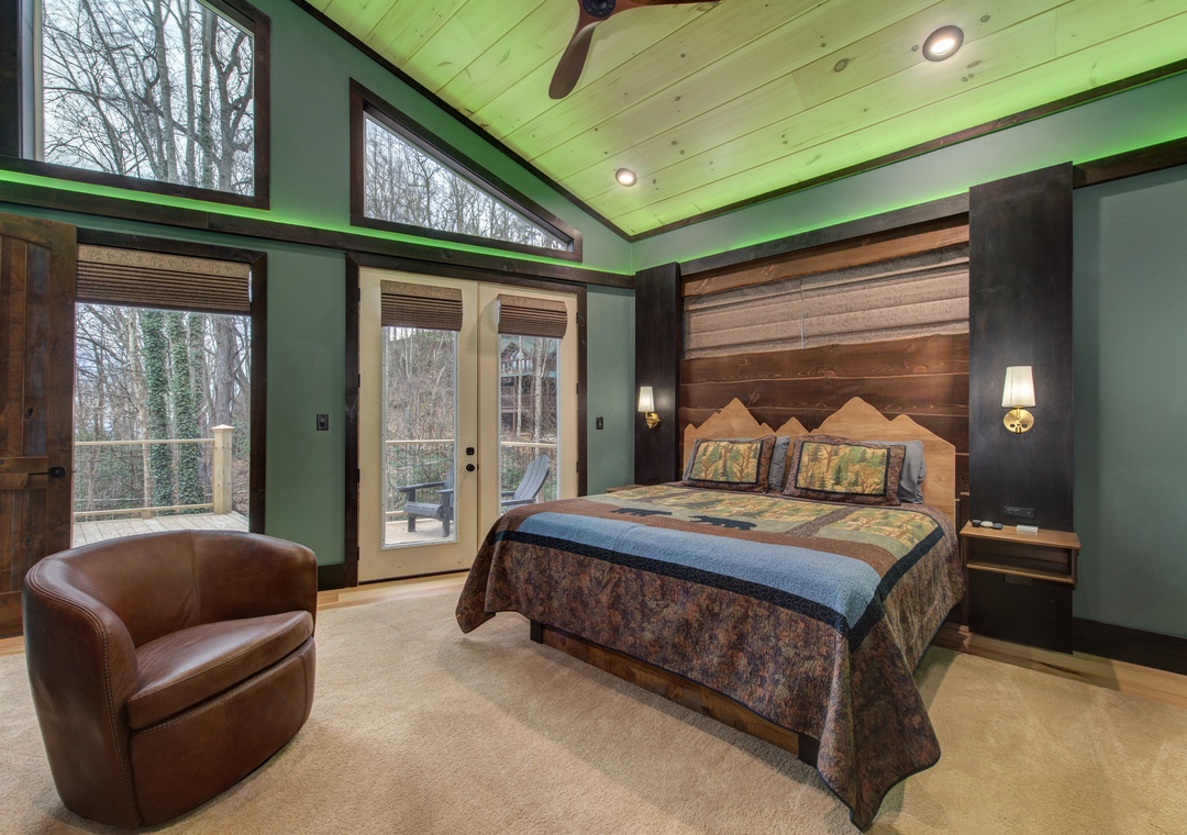 Relax in your mountain-inspired master suite with stunning wood ceiling, cozy leather chair, and French doors opening to your private outdoor space.