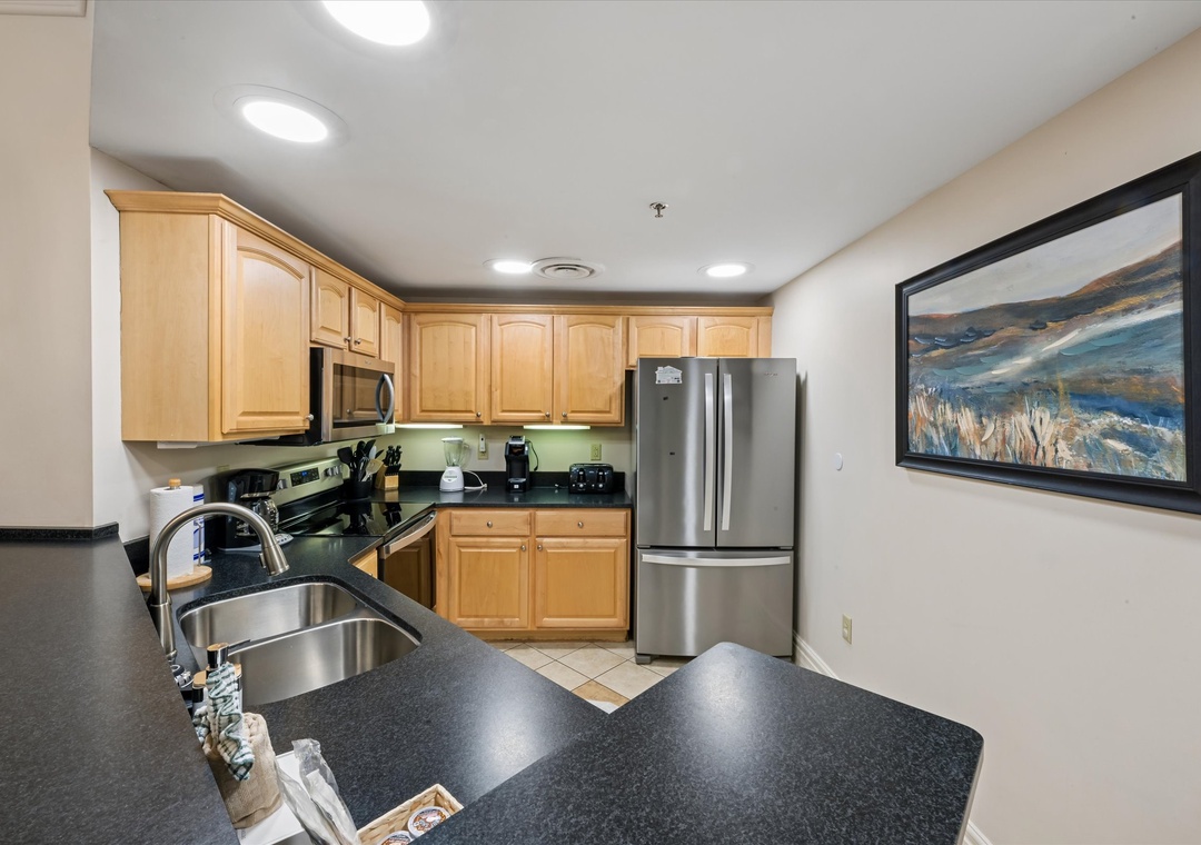 Your fully equipped kitchen features gleaming granite countertops, stainless steel appliances, and warm wood cabinetry for all your culinary adventures.