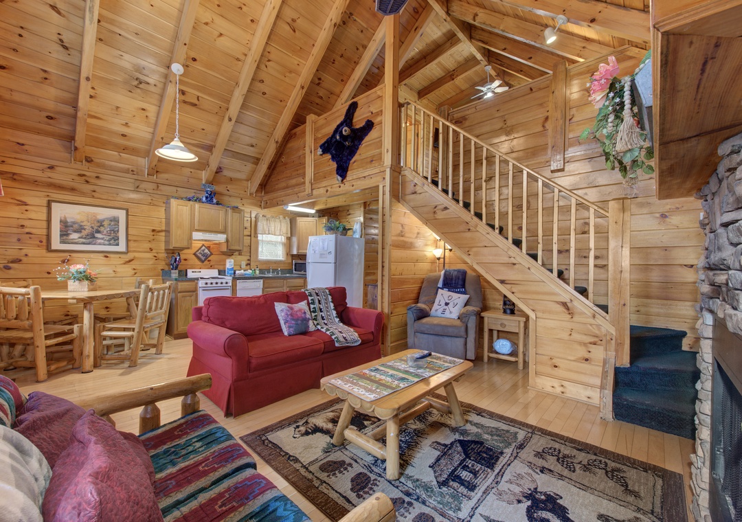 Cozy up in this charming log cabin with soaring ceilings, rustic furnishings, and warm wood throughout your mountain retreat.