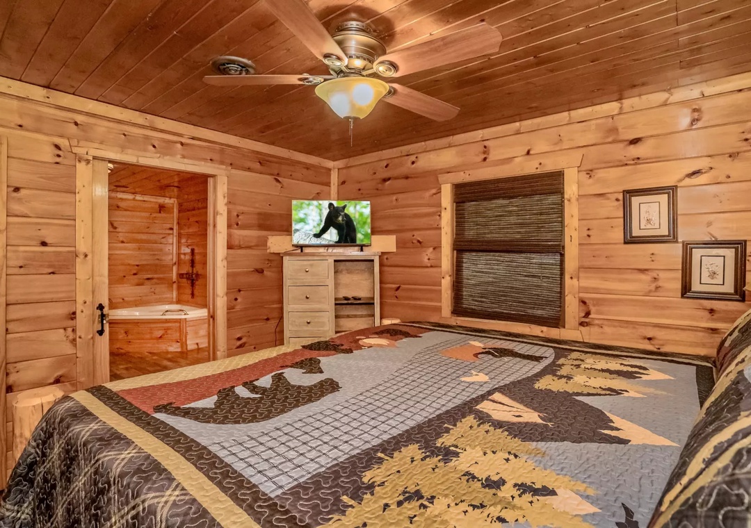 Unwind in your rustic bedroom with beautiful log walls, cozy quilt bedding, and your own TV for relaxing evenings in nature's embrace.