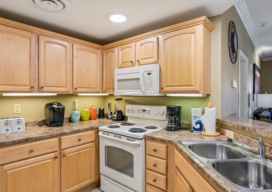 Your fully equipped kitchen features warm wood cabinets, granite counters, and everything you need to create memorable meals during your stay.