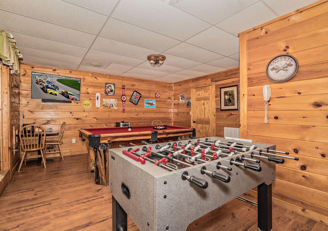 Your private game room awaits with foosball and pool tables, rustic wood walls, and vintage touches for endless entertainment.
