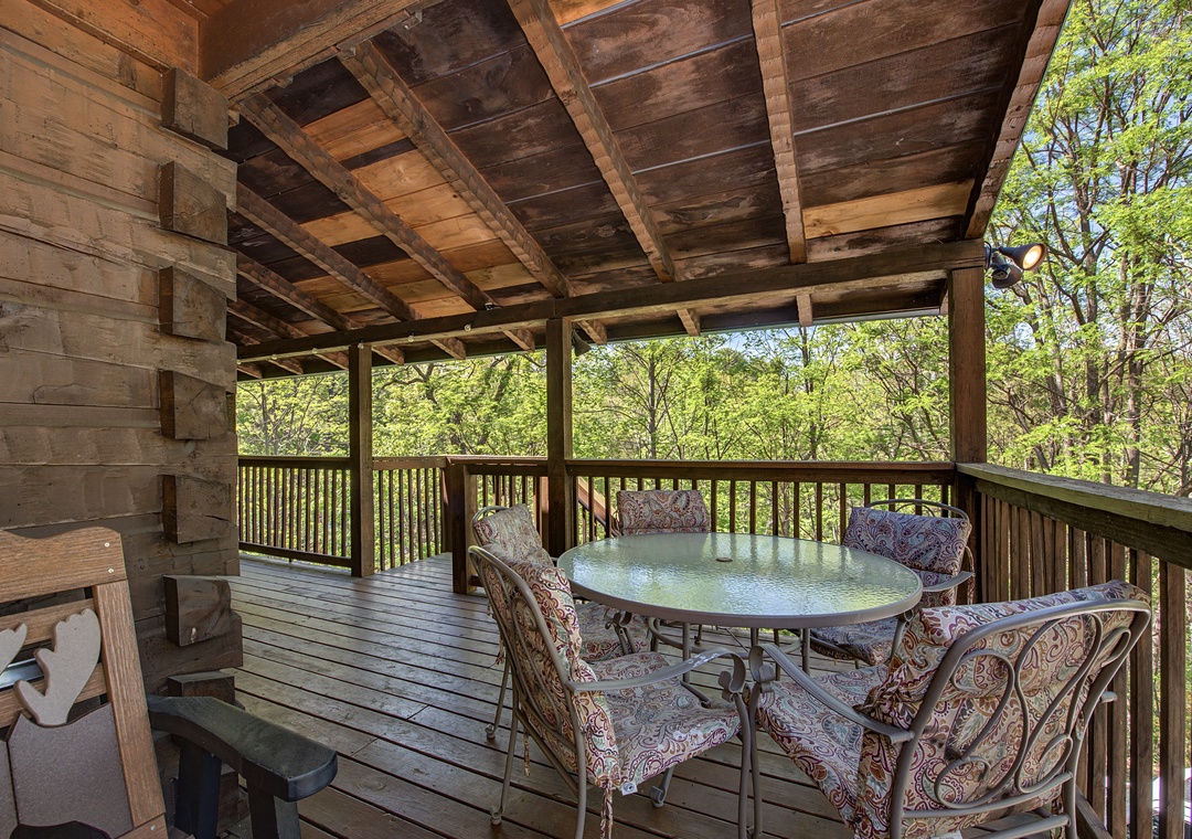 Savor your morning coffee on this rustic covered deck overlooking peaceful forest views.