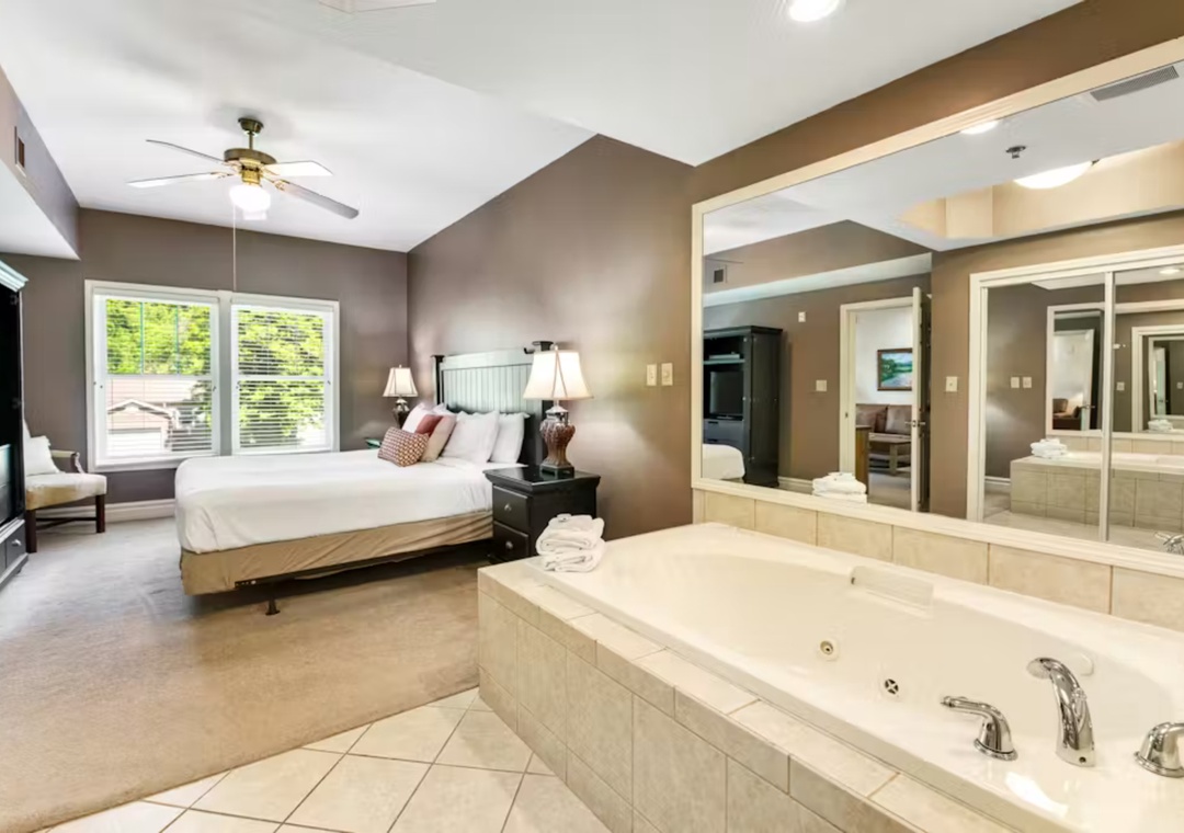 Unwind in your luxurious master suite featuring a jetted tub and spacious bedroom with modern amenities for ultimate relaxation.