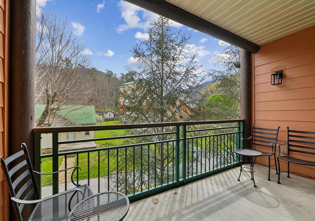 Sip your morning coffee on this peaceful mountain balcony, where rolling hills and clear blue skies create the perfect backdrop for relaxation.