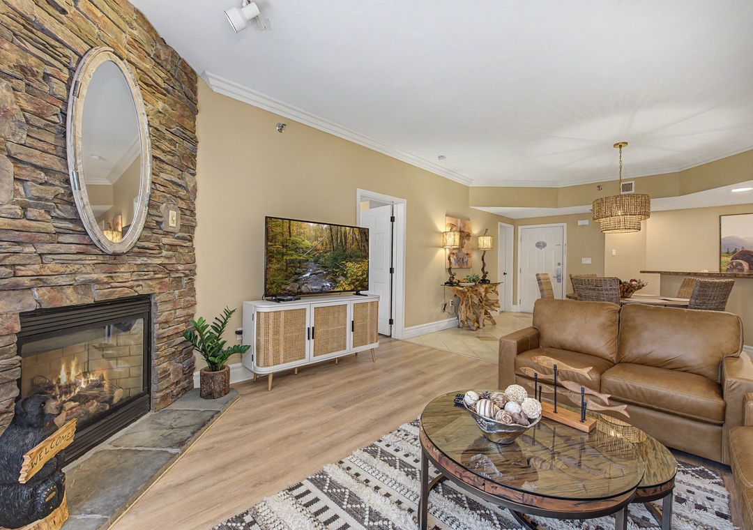 Unwind in your spacious living room where natural stone fireplace warmth meets modern comfort, perfect for cozy evenings together.