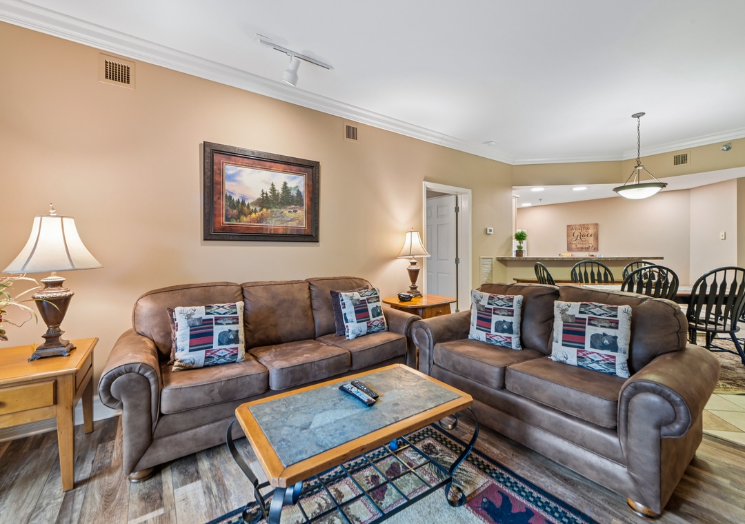 Sink into plush leather sofas where warm lighting and thoughtful touches create your perfect retreat for evening relaxation.