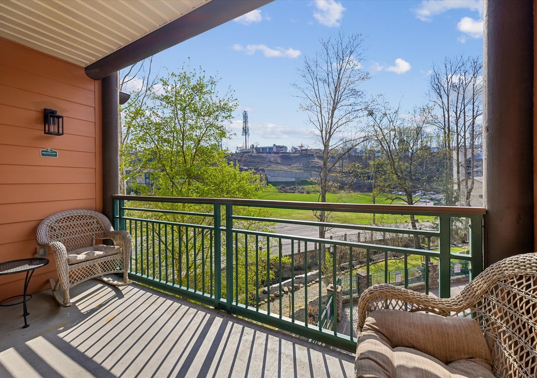Relax in cozy wicker chairs on your private balcony, where morning coffee tastes better with peaceful views stretching across the valley.
