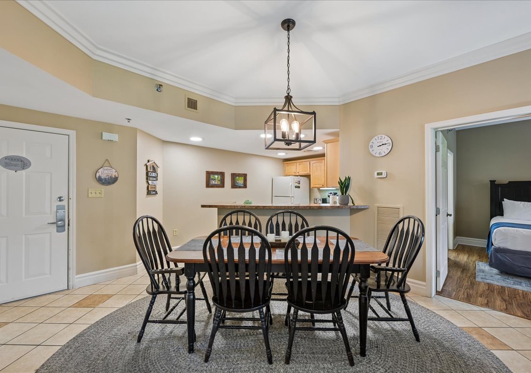 Gather around your spacious dining table where memorable meals and conversations unfold beneath the warm glow of elegant lighting.