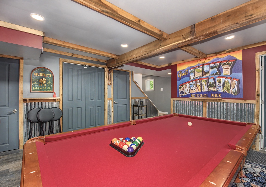 Challenge your travel companions to friendly competition on this welcoming billiards table, where exposed beams and playful decor create your perfect game-night atmosphere.