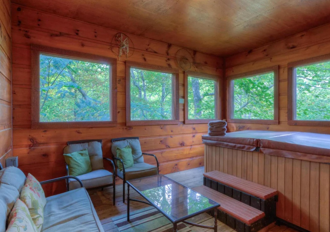 Unwind in your private hot tub surrounded by warm wood and forest views, where nature becomes your peaceful backdrop for ultimate relaxation.