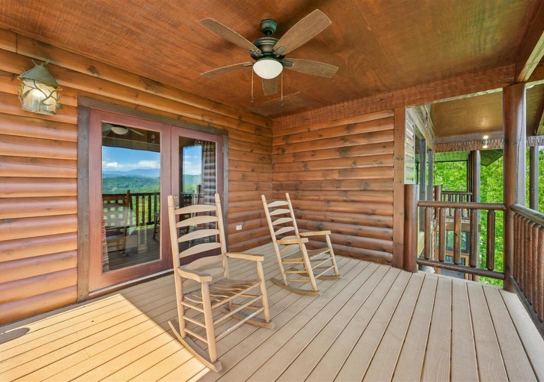 Relax in your private rocking chairs on this covered porch, where mountain views stretch across the horizon. The ceiling fan keeps you comfortable as you soak in the peaceful scenery.