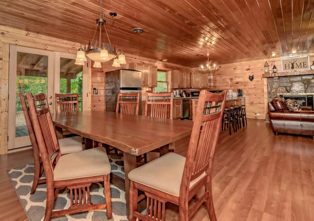 Gather around this spacious dining table where your group can share meals in warm cabin comfort, with the full kitchen ready for your culinary adventures.