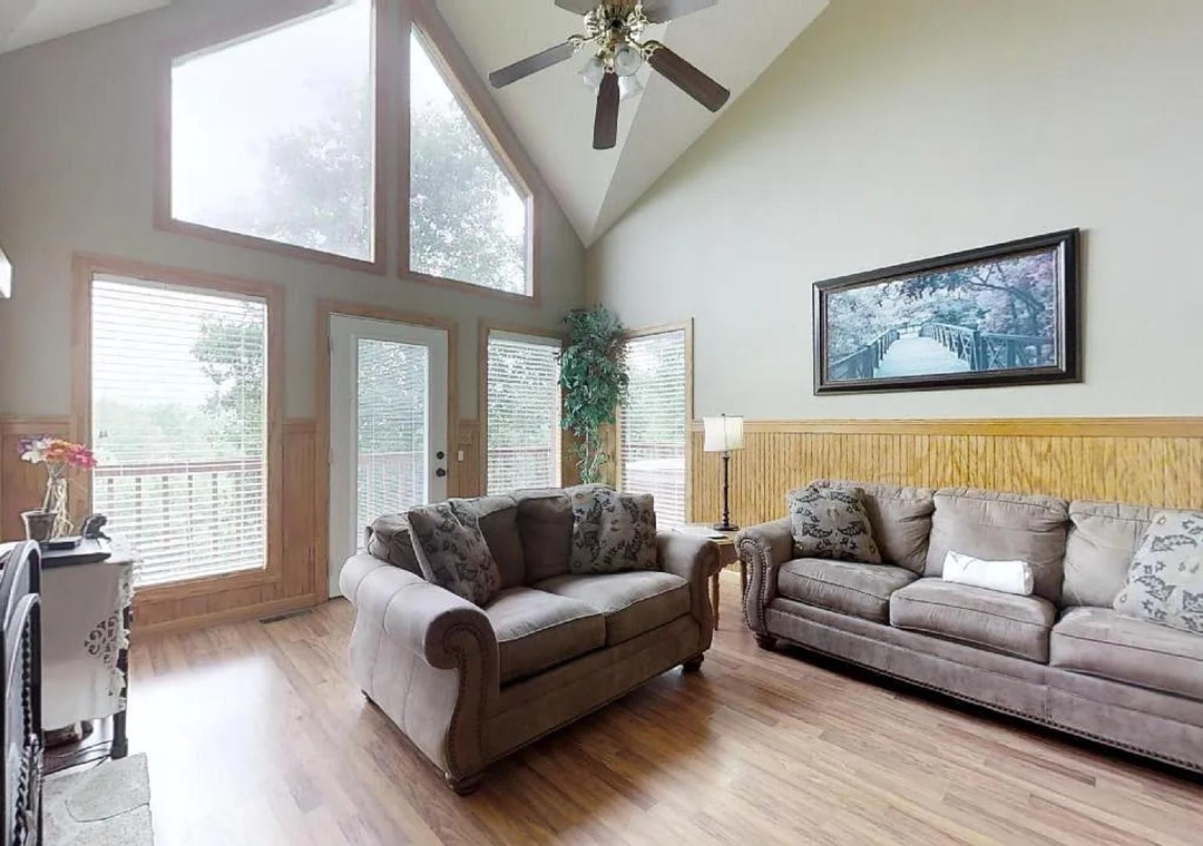 Relax in your light-filled living room with soaring ceilings, plush sofas, and scenic views—perfect for unwinding after a day exploring the area.